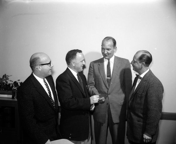 Mayor Ivan A. Nestingen, far left, is presented with the first ticket to the annual March of Dimes victory ball. Others include, left to right, Leslie Martin, E. J. Hutzenbuhler, and Jerry Bassett.