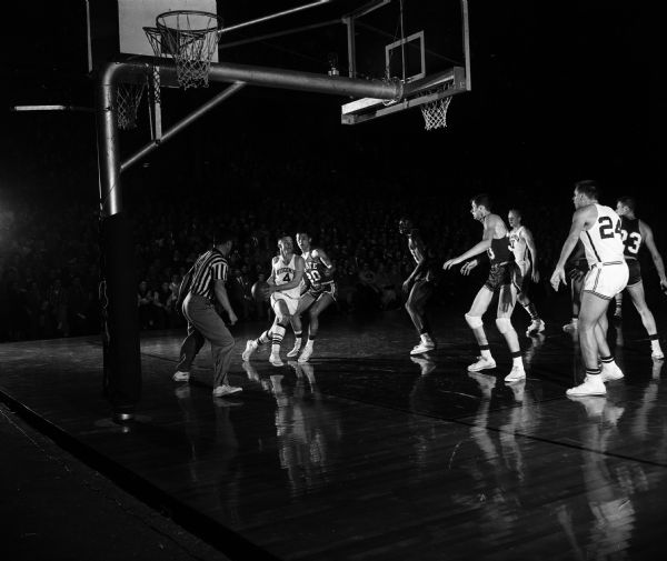Wisconsin's Walter (Bunky) Holt drives around Michigan State's Tom Rand during their basketball game at the University of Wisconsin Field House.