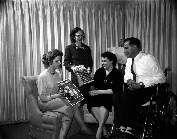 Because Chester Hartel, husband of the Wisconsin state president of Epsilon Sigma Alpha sorority is a polio victim, the three chapters of the sorority in Madison &#8212; Alpha Sigma, Alpha Xi and Beta Zeta &#8212; will aid the Mothers' March on Polio. Shown discussing plans are Tanis Wallace, publicity chair for the city council of ESA; Annabelle Hargrove, general chair for the three chapters assistance plan, Betty Hartel and Chester Hartel.
