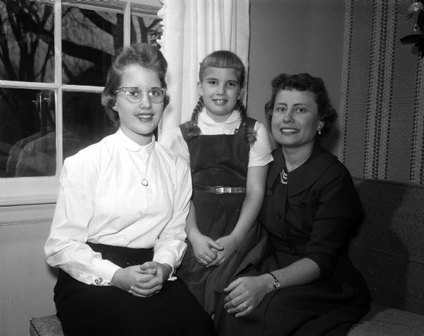 Mrs. Marzo P. (Eliza) Bliss, 4011 Birch Avenue, right, with her daughters, Merry, 14, and Carol, 8, was toastmistress for the annual mother-daughter banquet at the First Congregational Church, located at 1609 University Avenue at the corner of Breese Terrace.