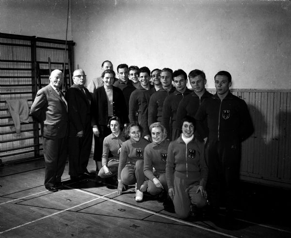 Group portrait of the West German men's and women's gymnastics teams at Turner Hall. They are in Madison to perform at the University of Wisconsin field house. Also shown is (standing at the far left) Oscar Drees, vice-president of the German Turner organization.