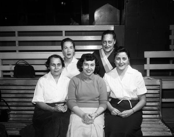 Group portrait of five members of the Gisholt Gals Bowling Team who were the leading team in Class D of the Wisconsin Women's Bowling Association tournament in Milwaukee. Front row, left to right: Mary Jane Riemer, Pat Murray, Jean Roberts. Back row, Beverly Nelson and Wilma Winters.