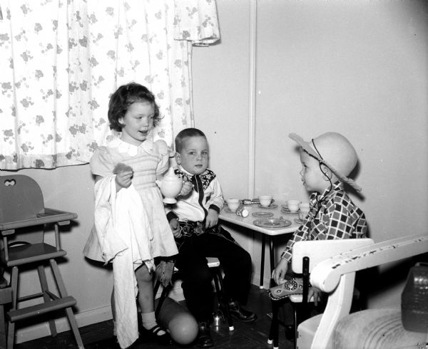Children who are part of the Healy Lane play group entertain themselves at the Wind home at 5410 Healy Lane in Monona. They are, from left to right, Randi Jo Wind, 4, John Dahl, Jr. 4, and Danny Lee Smith, 3.