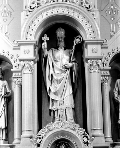 A statue of St. Patrick stands at St. Patrick's Catholic Church, located at 410 East Main Street.