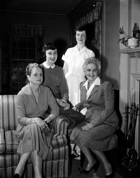 Mrs. Robert (Helen) Bruce, 105 Shepard Terrace; Miss Marilyn Class, 152 Langdon Street, president of the collegiate chapter; Miss Dorothy Morrell, 1313 St. James Court, a senior physical medical major; and Mrs. W. S. (Sara Belle) Slemmons, 152 Langdon Street, the sorority house mother, assist in making plans for the guest meeting of the Alpha Chi Omega Mothers' Club and Alumnae Group event planning committee.