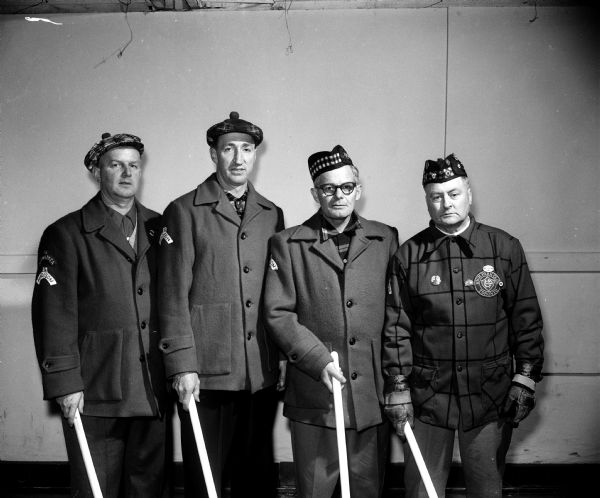 Group portrait of members of the Jim McIntosh Curling Rink of Toronto, Ontario, Canada. The teammates were winners of the Madison Curling Club's annual invitational bonspiel. Left to right: Ken Betts, Ted Sellers, L.E. Ross, and Skip Jim McIntosh.