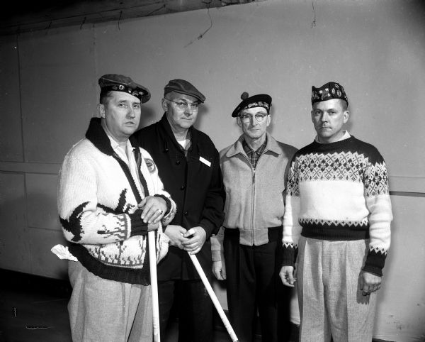 Group portrait of members of the Bob Anderson curling rink of Waltham, Illinois, winners of the second event of the annual Madison Curling Club's invitational bonspiel. Left to right: William Vogelsan, Milt Dewey, Clarence Wilson, and Skip Bob Anderson.