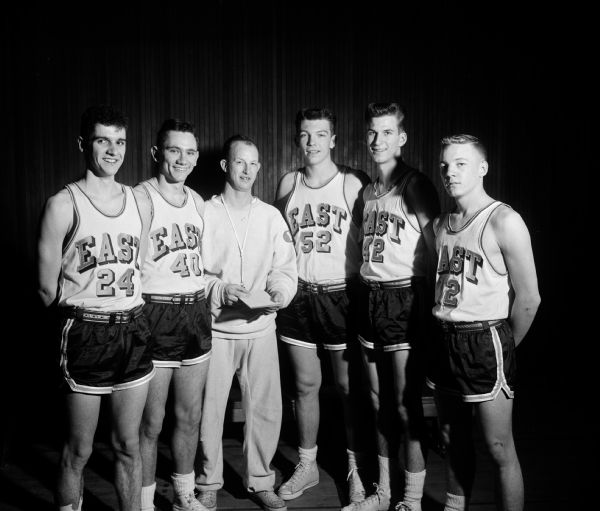 The starting five for Madison East High School basketball team compete in the state tournament. From left are: Bob Powers, Ron Staley, coach Verlyn Belisle, Pat Richter, Dave Heisig, and Dale Holzhuter.