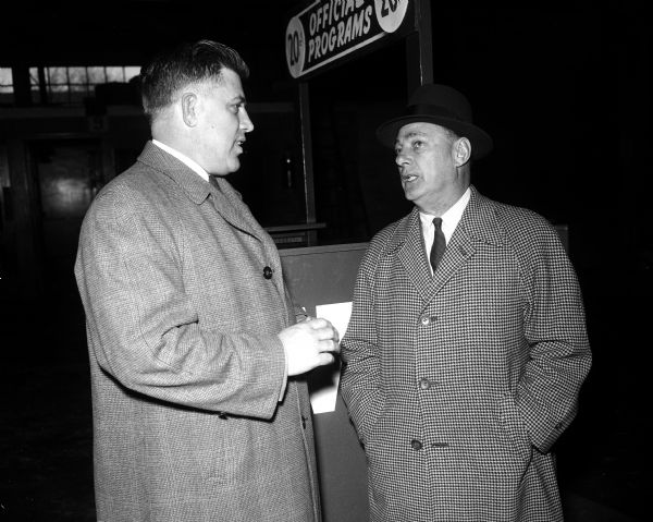 Harry Stuhldreher (right), former Wisconsin football coach and athletic director, talks with Milt Bruhn, present Badger football coach.