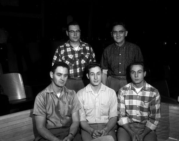 Group portrait of the five members of the Triggs Bakery bowling team, comprised of Bill Triggs and his four sons. Seated in the front row are Phillip, Stephen, and Stanley. Standing in the back row are Raymond and Bill. They competed in the Knights of Columbus 7 p.m. League at Dream Lanes.