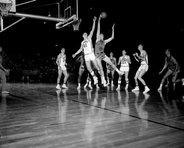 Action photograph of the basketball game between the University of Wisconsin and Notre Dame in the fieldhouse.