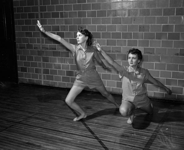 Judy Lunde (left) and Judy Borquist (right) striking dance poses in an interpretive dance class at East High School.