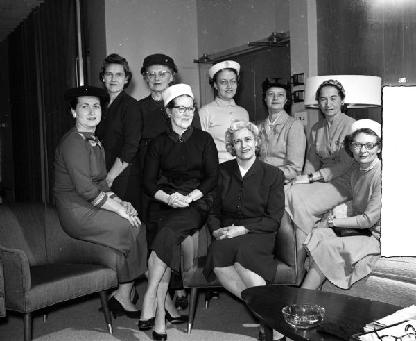 Nine members of a Madison medical auxiliary group.