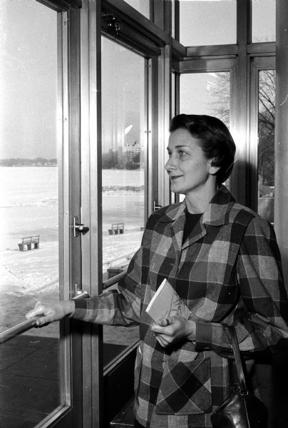 Mrs. William Bowersox of Juneau pausing indoors for a look out at Lake Mendota before attending a session for women at the annual University of Wisconsin Farm and Home Week.
