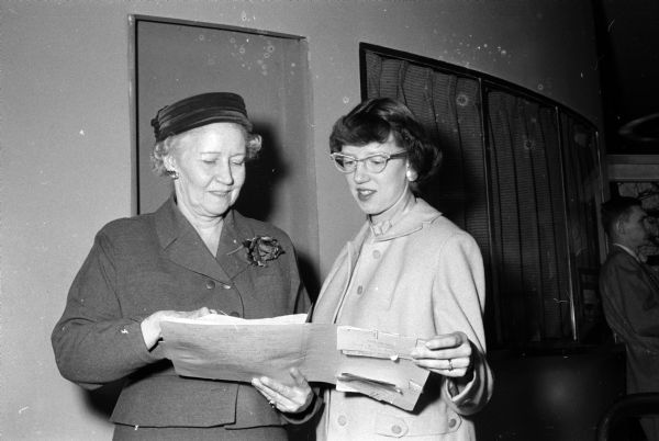 Two home economics extension workers comparing notes during the annual University of Wisconsin's Farm and Home Week. At left is Edith Bangham of Madison, assistant state leader in Wisconsin. At right is Mrs. Elizabeth Rosandick of Wisconsin Rapids, assistant home agent of Wood County. She is the daughter of Mrs. Madge Grimmer of Madison.