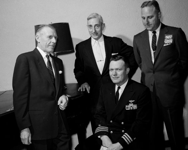 Four guests at the Madison Chapter Military Order of the World War cocktail and dinner party include, from left to right: Capt. Leslie K. Pollard, Col. Paul I. Freiburger, Cmdr. Earl E. Watson (seated), and Col. Chester F. Allen.