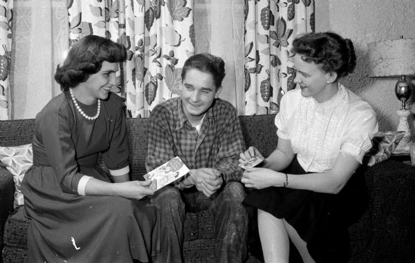 Lasslo (Larry) Csukardy, a Hungarian refugee, receives the first Valentines of his life from Mrs. Don Andree, on the left, and Mary Natvig, a teacher at Seminary Springs School.