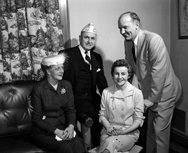 Group portrait of two dignitaries with their wives that took part in the banquet honoring the president of the national auxiliary of the Veterans of Foreign Wars. Lyall T. and Christine Beggs are on the left. He was the master of ceremonies and is a former national commander. On the right are Ivan and Geraldine Nestingen. Mayor Nestingen welcomed the group to Madison.