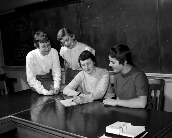 Members of Philomathia, a service club at Wisconsin High School, host a formal dance called "Pagoda Paradise." Officers are, left to right, Karen Olson, Raymond Road, treasurer; Judy Knapp, 1319 Farwell Drive, vice president; Judy Winterbotham, Fox Bluff, secretary and Pat Felt, 3722 Atwood Avenue, president.