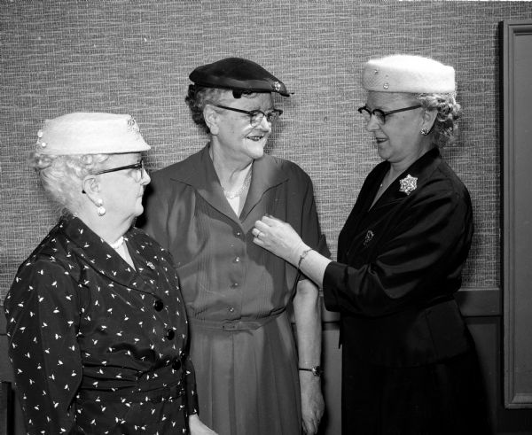 Mrs. James A. (Mittie) Slightam, 341 West Wilson Street, left, and Mrs. C.A. (Esther) Bonham, 1825 Van Hise Avenue, center, were honored for 40 years of membership in the Grand International Auxiliary to the Brotherhood of Locomotive Engineers. Mrs. Charles (Gertrude) Adams, 1042 East Main Street, right, presents the pins to them.