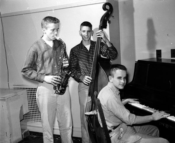 Group portrait of one of the musical combos that participated in Wisconsin High School Orpheus Club's Orpheus Show, titled "Mickey Moose Club, Anything Can Happen Night". From left are Ronald Roesaler, Oz Marshall, and Roy Hamel.