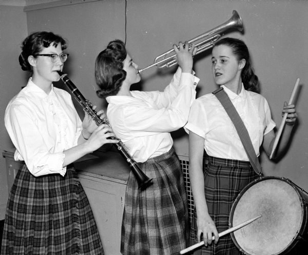 Group portrait of three musicians that took part in Wisconsin High School Orpheus Club's Orpheus Show, titled "Mickey Moose Club, Anything Can Happen Night". From left, they are Karen Isaksen, Annetta Evenson, and Sharon Mack.