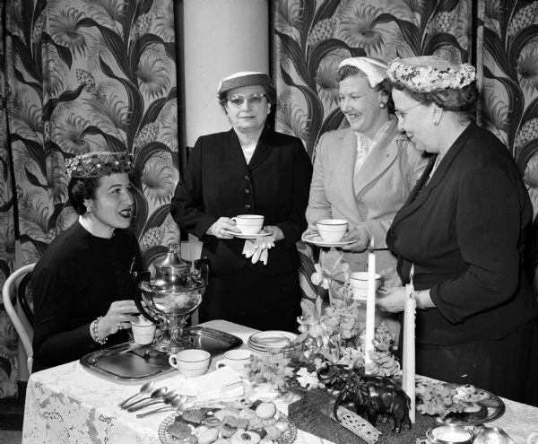 Representing their church at an inter-faith tea are, from left: Catherine Gedko, Baha'i; Mrs. John English, First Methodist; Doris Voit, Plymouth Congregational; and Mrs. R.H. Roberts, Bethany Methodist. The tea is sponsored by the Madison Council of United Church Women.