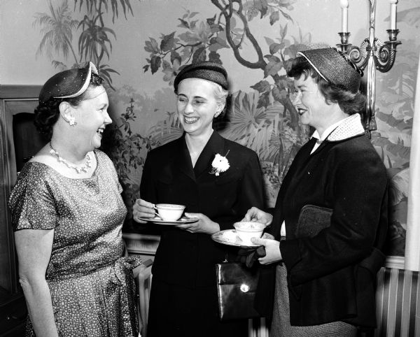 Members of the Wisconsin League of Women Voters enjoying tea at the executive mansion following a session at the Wisconsin State Capitol for the league's legislative school. From left are Mrs. Milan Neff of Verona, Mrs. Janet Berger of Madison, and Mrs. R.G. Herb of rural Madison.