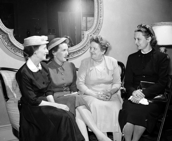 Four Madison members of the Wisconsin League of Women Voters enjoying tea at the Executive Mansion after a session at the Wisconsin State Capitol for the league's legislative school. From left are Mrs. Betty Doremus, Mrs. Ruth Clinard, Mrs. Lucinda Lilja, and Mrs. Jane Weston.