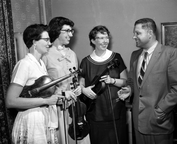 Former members of the Madison String Sinfonia attending a surprise party to honor conductor Marie Endres during an observance of the 20th anniversary of the group. Left to right: Alice Peet, Hyattsville, Maryland; Donna Zimmerman, Chicago; Rosemary Coyne Girardot, Akron Ohio and Marshall Miller, Maiden, Missouri.