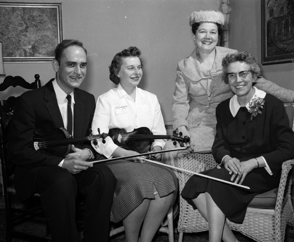 Attending a surprise party to honor conductor Marie Endres during the observance of the 20th anniversary of the group are present and former concertmasters and Marie Endres. Left to right: John Fredrickson, Chicago; present concertmaster Mary Perssion, Madison; Catherine Odenahl, Milwaukee and Miss Endres.   
