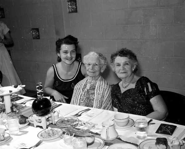 At left is Mrs. Amy Levander (left) sitting with her 98-year-old grandmother, Mrs. Ella Stevenson, and her mother, Mrs. W.G. Gerlach, during a three-generation portrait taken at the spring banquet of the East Side Women's Club.