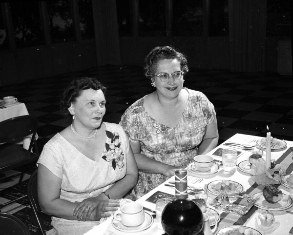 The new president of the East Side Women's Club, Mrs. Evelyn Fletcher (left), is shown with the retiring president, Mrs. Beulah Von Eschen, at the annual spring banquet.