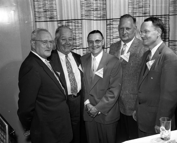 From left to right, Master of Ceremonies Harold Jensen chats with Jim Pertzborn, past president of the West Side Business Men's Association; C.J. Blum, a director of the East Side Business Men's Association; and Emmett Bergenske, past president of the East Side Business Men's Association at the Tri Association Council Night.