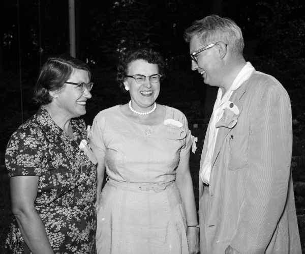 Family and friends of the Madison Press Club enjoy the refreshments and entertainment at a picnic on the grounds of the Fauerbach estate, located north of Madison. Left to right: Dorothy Custer, Eleanor Browy and Robert Taylor.