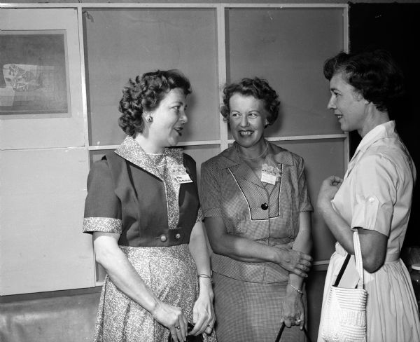 Helen Legg (left), president of the Truax Field Officers Wives Club, talks with two new members, Mrs. W.C. Butterfield and Mrs. Earl H. Killgore.