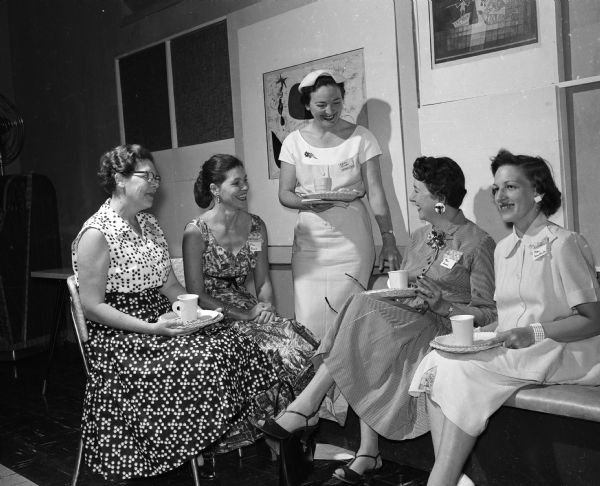 The Truax Field Officers' Wives Club hosts a party for newcomers. Guests include, from left: Mrs. Edward D. Curry, Mrs. A.J. House, Edith Steere, Mrs. Wilbert Jones, and Patricia Van Hutta.