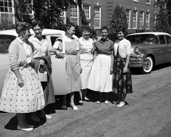 Five new St. Mary's Hospital School of Nursing students gather in front of the nurses' dormitory while preparing to leave on a tour of Madison with tour guide Margaret Stephan, member of the St. Mary's hospital auxilary. Left to right: Mary Buenzli, Madison; Lucille Ballweg, Mazomanie; Margaret Stephan, Madison; Jane Banaszak, Crivitz; Charlotte Pagano, Pewaukee; and Nanciann Adler, Cross Plains.