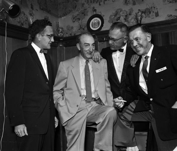 Jim Keegan (left), "Sticker" Hampton, and Paul Prestegard, all of Richland Center, and Bill Schorer, Reedburg, attend a birthday party for Joseph "Roundy" Couglin at the Top Hat.  Roundy was a popular sports columnist for the <i>Wisconsin State Journal</i>.