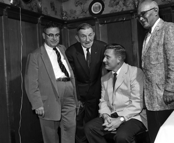 Nick Christokas, Richland Center; Ed Stoeber, Middleton; Perry Moss, Badger backfield football coach; and Mannie Simon, Madison, attend a birthday party for Joseph (Roundy) Coughlin at the Top Hat. Roundy was a popular sports columnist for the <i>Wisconsin State Journal</i>.