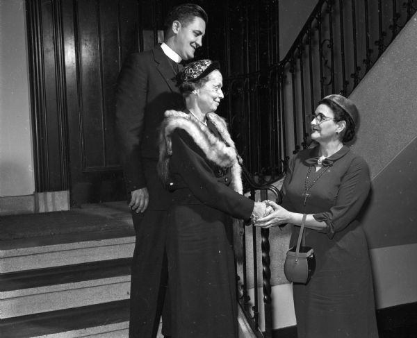 Eleanor Nerdrum, Madison, chairman, greets early arrivals at the Northwest Convocation of Episcopal Women held at Grace Church. Shown with her are the Reverend Canon Gordon Olston, Milwaukee, and Alice Davis Borman (formerly of Madison) Milwaukee, president of the Diocesan Women's Auxiliary.