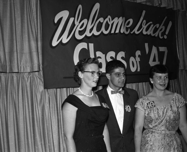 Officers of the class of 1947 stand in front of a class banner. Officers include Mrs. William Navin (Mary Lang), Minneapolis, secretary; Sam Prestigiacomo, Madison, president, and Mrs. John Roach (Mary Gene Heller) Madison, treasurer.