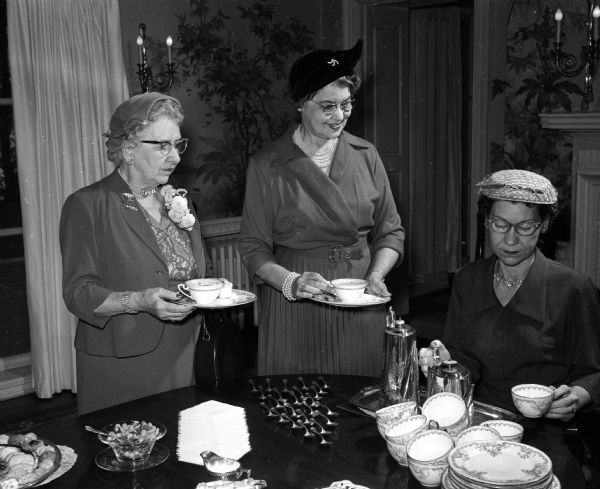 Jessie Harloff, chairman of the finance committee, Minnie Whipple, state affiliations chairman and parliamentarian, and Evalyn Herriot, corresponding secretary enjoying the tea that Mrs. Thomson hosted for members of the Madison Business and Professional Women's Club.