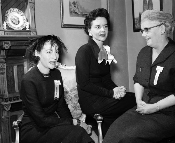 Three officials of the Madison branch of the American Association of University Women (AAUW) are shown at their fall tea held at the College Club, 12 East Gilman Street. Left to right, they include Clarine Smissman, chairman of the state AAUW's legislative program; Joon Miller, membership chairman and co-editor of the Bulletin; and Mrs. E.E. Evans, a vice-president of the State AAUW.