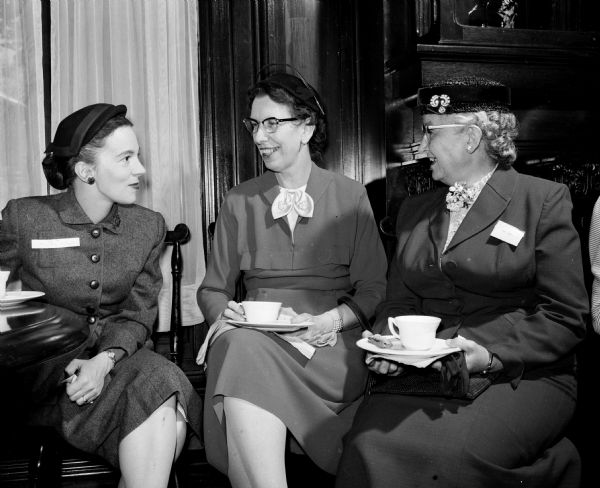Mary McHugh; Marion Ludden; and Alice Wood, editor of the AAUW Bulletin, enjoy tea in the College Club library.