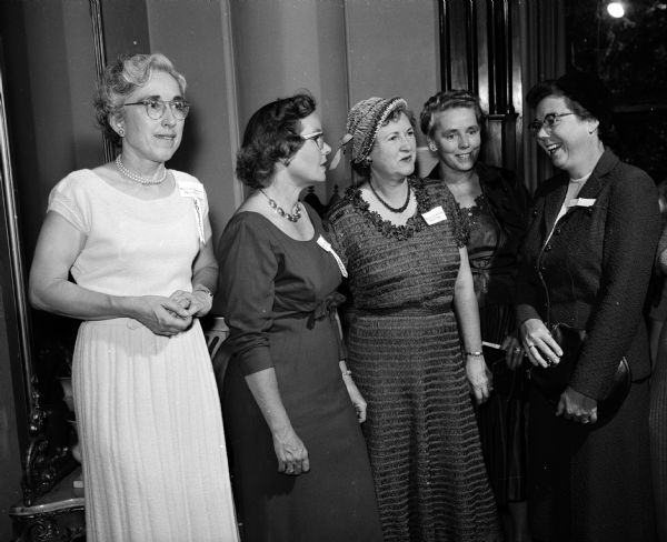 Mrs. Edward A. Schilf (far right), a new member, is shown engaging members of the receiving line. From left to right, they are Laura Munson, president of the Madison AAUW branch; Janet Schlatter, first vice-president and chairman of the program committee; Lucille Kimball, secretary; and Nettie Fairchild, fellowship chairman.