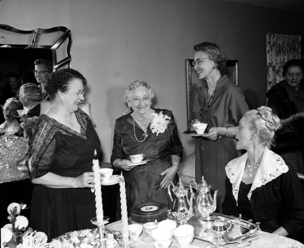 A group gathers for a tea in honor of Helen E., wife of Edward T. Fairchild, former chief justice of the Wisconsin Supreme Court. They include, from left, Margaret, wife of Grover Broadfoot; Helen E. Fairchild; Mrs. Thomas E. Fairchild, Milwaukee; and Louise, wife of Timothy Brown. The women are all married to justices of the State Supreme Court.