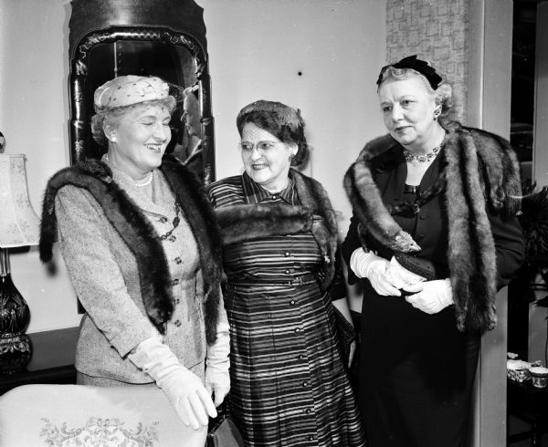 (Left to right): Gertrude, wife of attorney Francis Lamb; Mrs. Howard L. Hail, University of Wisconsin law professor; and Inez, wife of attorney Oscar T. Toebaas attend a tea in honor of Helen E., wife of Edward T. Fairchild, former chief justice of the Wisconsin Supreme Court.