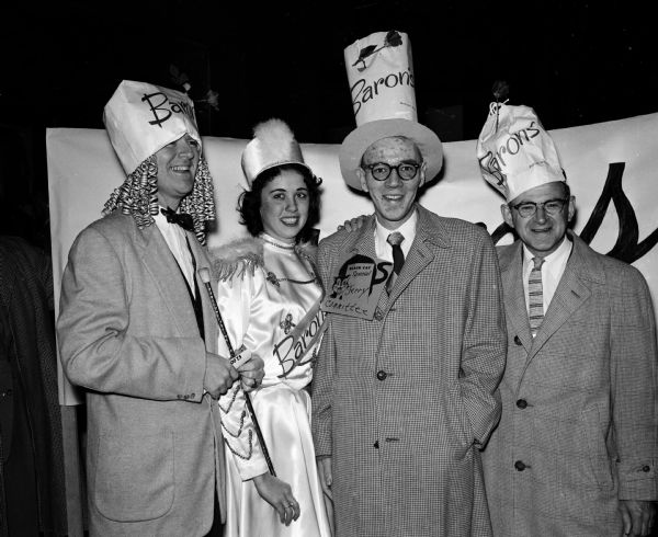 Four employes of Baron Brothers posing wearing paper hats. They include (from left): Jesse Fillmore, Joyce Taylor, Jerry Nestley, and Jim Holdorf.