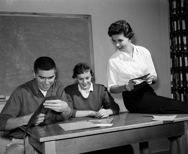 Working on name tags for the Luther League convention at Luther Memorial Church are, left to right: James Goetz, Bobby Jo Petersen, and Joan Risley.